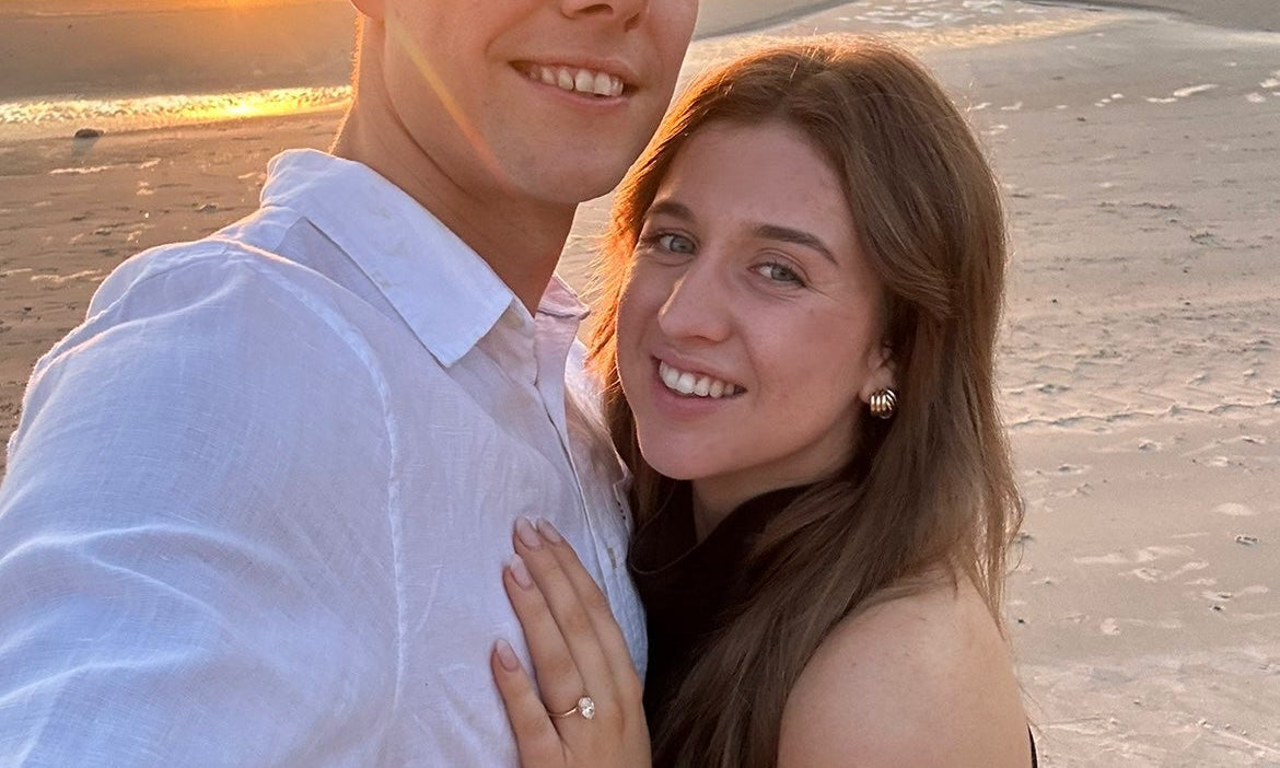 Ellyana and Kyle engagement photo with bespoke Grace engagement ring featuring hidden halo and birthstones