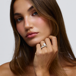 Grace oval diamond engagement ring on hand with 18ct yellow gold bead and claw set band