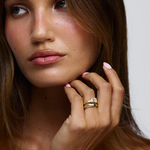 East west emerald cut diamond ring emphasizing slim tapered band and elongated finger look