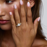 18ct yellow gold cushion cut solitaire ring with baguette shoulder stones and paved eternity band on hand