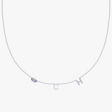 Silver personalized charm necklace with blue gemstone and initial C H letters