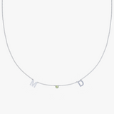 Silver beaded chain necklace with cutout M and D letters plus green gemstone pendant