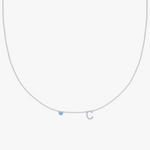 Silver-toned charm necklace with blue gemstone and letter C pendant on delicate chain