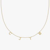 Solid gold personalized charm necklace with custom letter pendants C, J, B on round-link chain