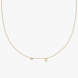 Yellow gold charm necklace with diamond and letter F initial pendant