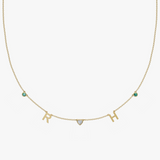 Yellow gold charm necklace with letter R and H initials, heart stone, and teal birthstone gems