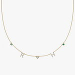 Yellow gold charm necklace with pave diamond initials RH, heart and teal birthstone charms