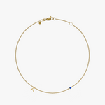 Yellow gold charm bracelet with initial 'A' and blue birthstone