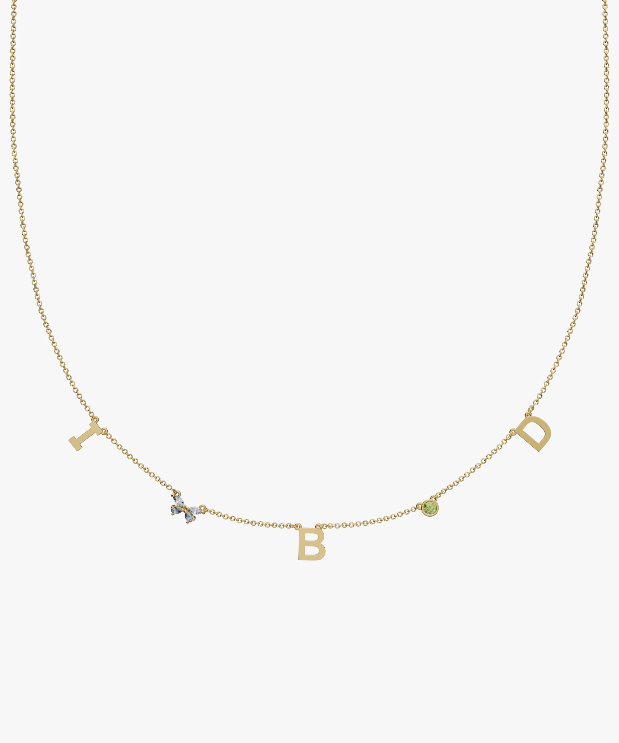 Yellow gold charm necklace with initial letters, green birthstone and floral diamond detail