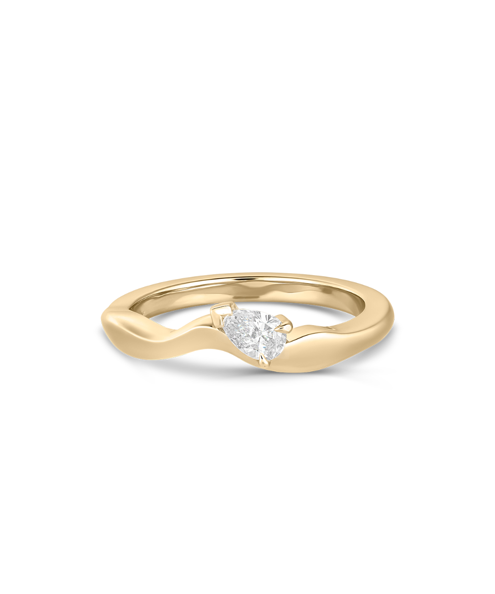 A yellow gold wavy band ring featuring a single pear-cut diamond center stone, shown on a clean white background.