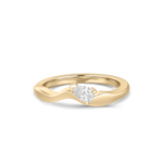A yellow gold wavy band ring featuring a single pear-cut diamond center stone, shown on a clean white background.