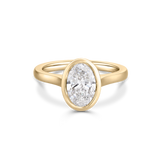 Isolated 18ct yellow gold oval diamond bezel engagement ring with smooth tapered band