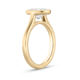 Side profile of 18ct yellow gold oval diamond bezel setting showing modern floating silhouette