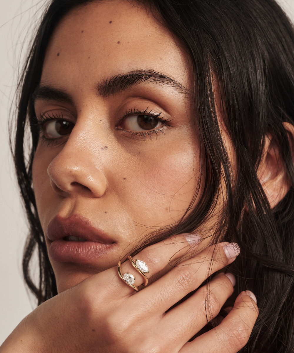 Astra Marquise Natural Diamond Pinky Ring in yellow gold with claw setting layered on oval ring