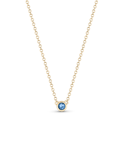 Blue birthstone pendant on gold oval link chain against white background