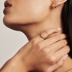 Side profile of pear yellow diamond huggie earring with signet ring