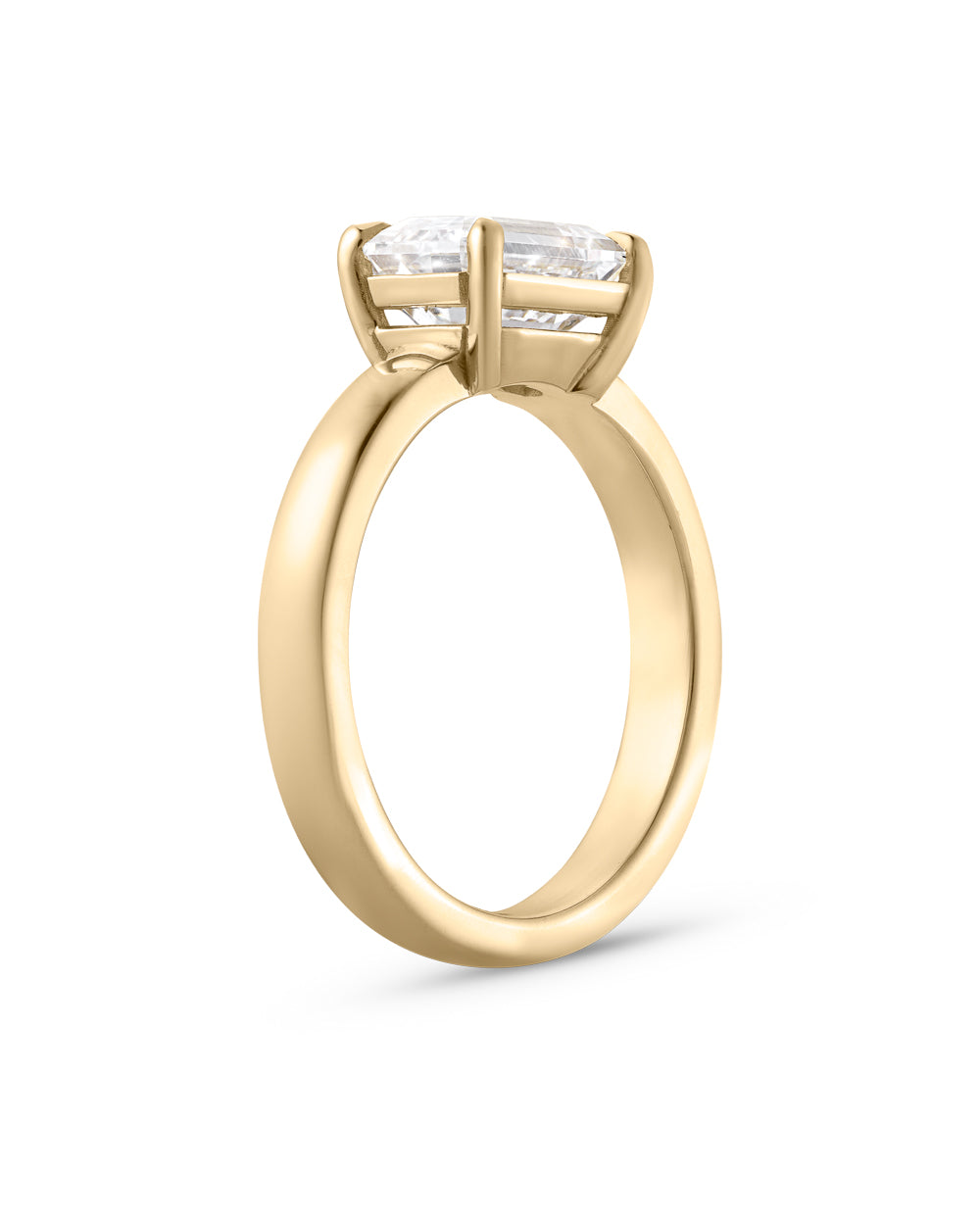 Isolated side view of 2.01ct east west emerald cut diamond ring in 18ct yellow gold