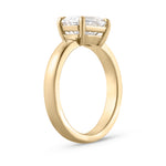 Isolated side view of 2.01ct east west emerald cut diamond ring in 18ct yellow gold