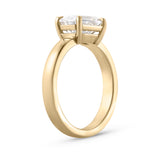 Isolated side view of 2.01ct east west emerald cut diamond ring in 18ct yellow gold