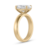 Side profile of Harper oval diamond ring showing thick polished 18ct yellow gold band and elevated prong setting