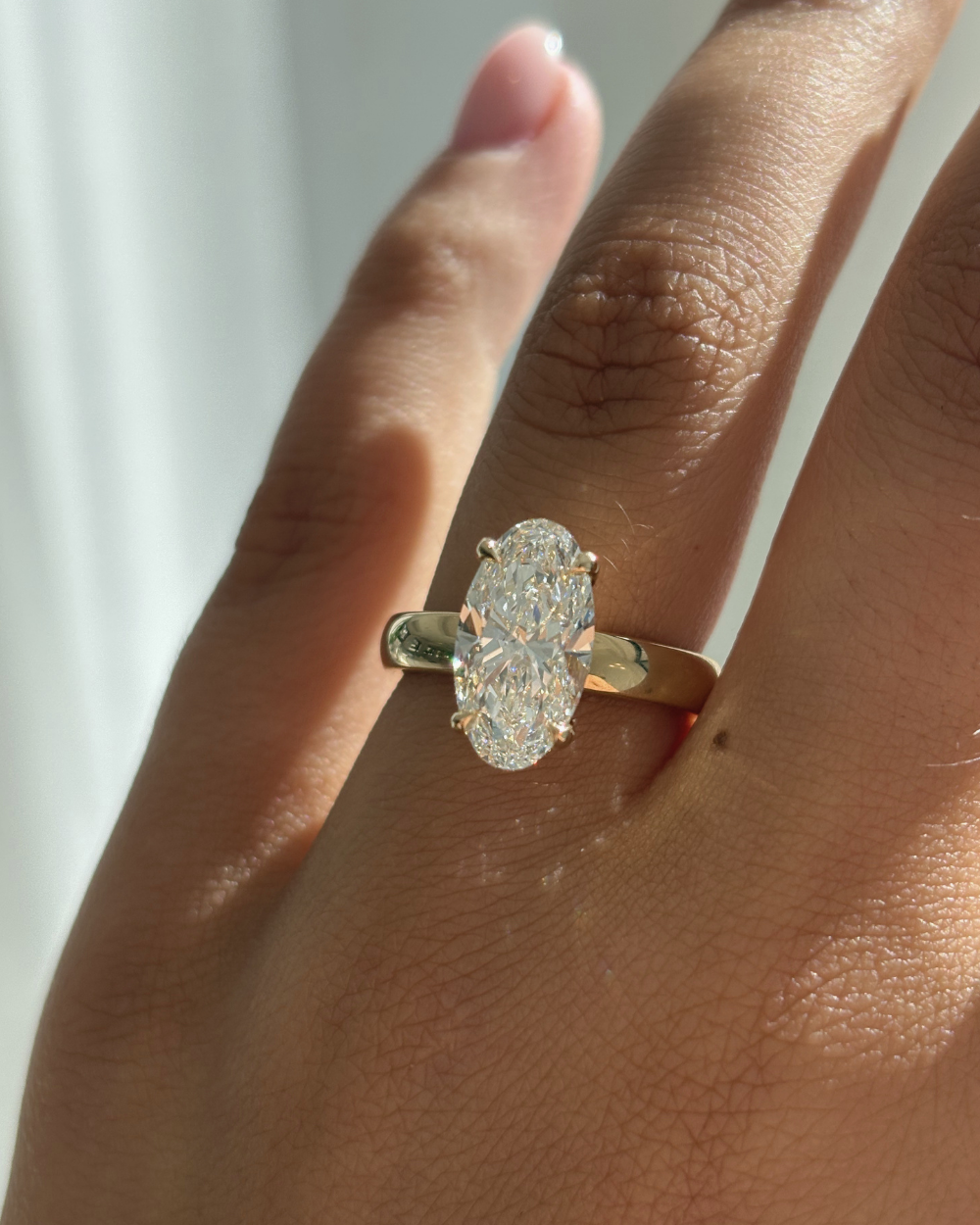 Harper 3.08ct oval lab grown diamond ring worn on finger highlighting fit and sparkle