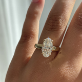 Harper oval lab grown diamond engagement ring on hand with 18ct yellow gold claw setting