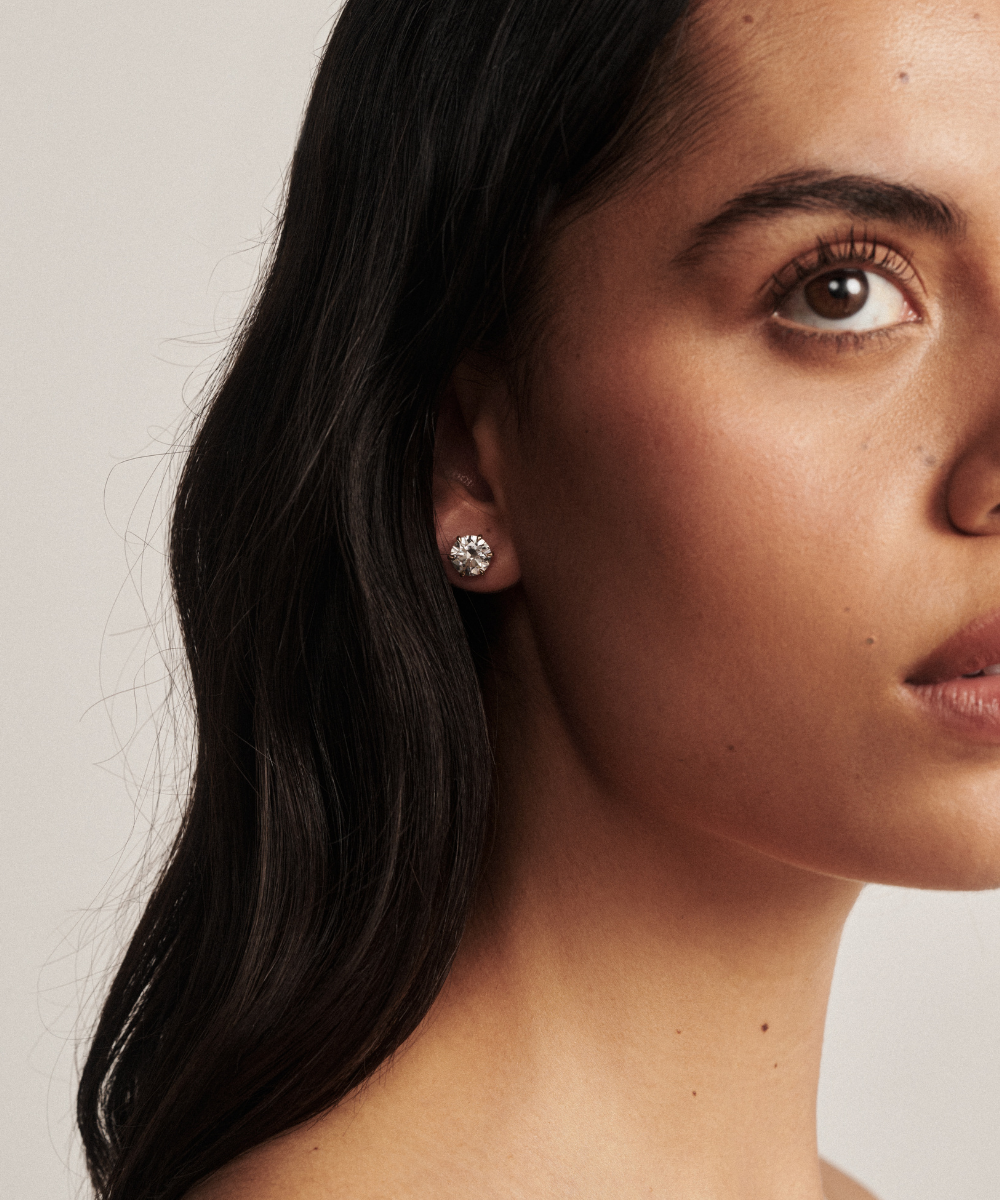 Jessica round diamond stud earring worn on earlobe with six-prong white gold setting