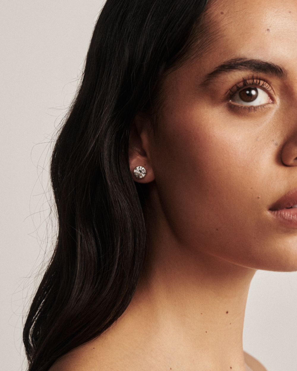 Jessica round diamond stud earring worn on earlobe with six-prong white gold setting
