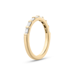 Side view of 18ct yellow gold baguette diamond wedding band with claw-set stones