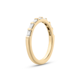 Side view of 18ct yellow gold baguette diamond wedding band with claw-set stones