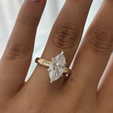 Side view of marquise cut diamond ring highlighting height and yellow to white gold transition