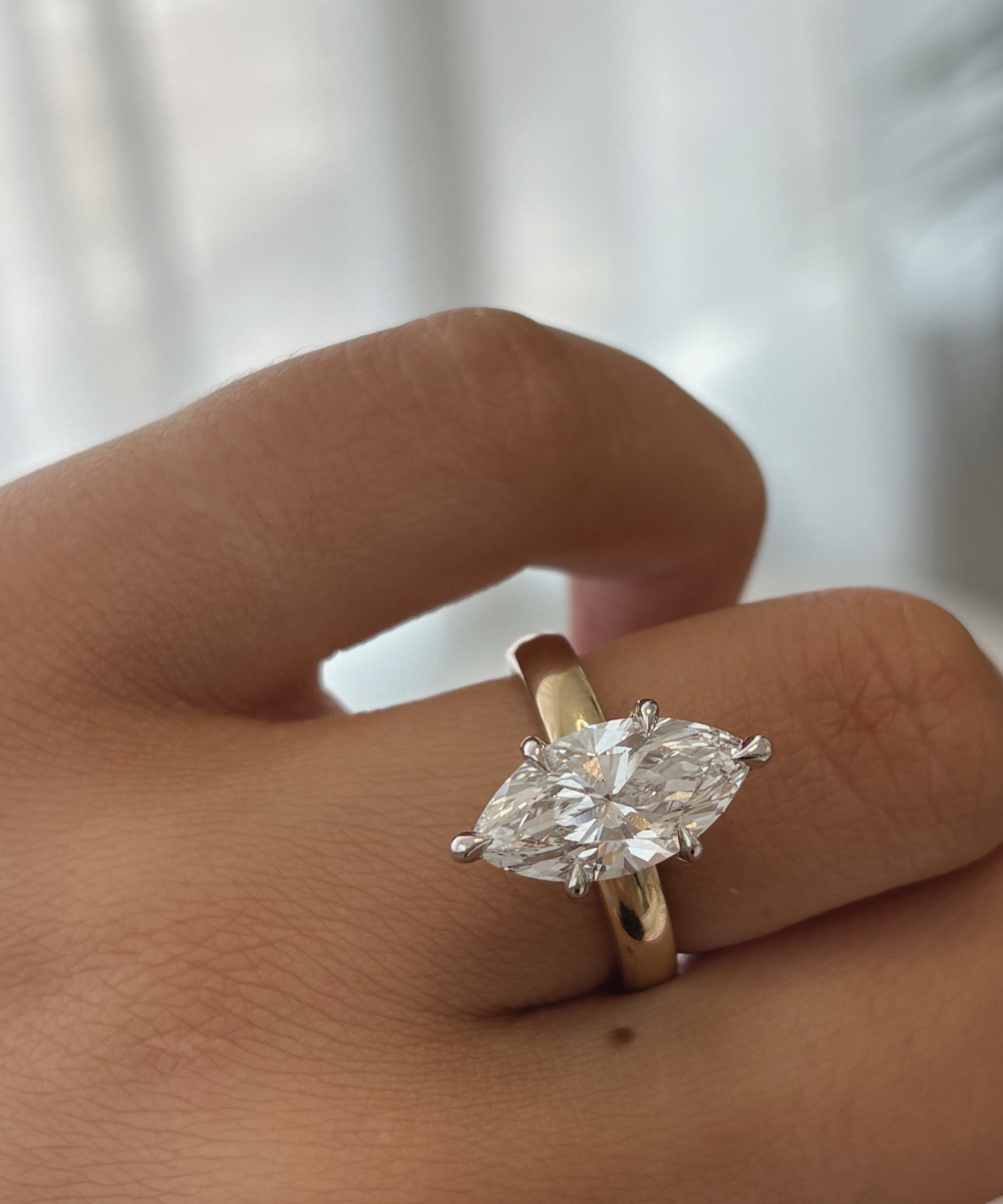 Marquise lab grown diamond ring on finger showing two-tone metal contrast and fit