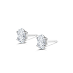 White gold oval diamond stud earrings with butterfly backs visible