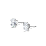 White gold oval diamond stud earrings with butterfly backs visible