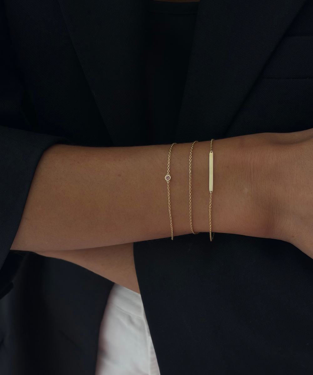 Stacked gold bracelets lifestyle shot