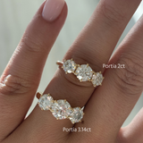 18ct yellow gold Portia trilogy engagement rings side-by-side on fingers showing 2ct and 3.14ct lab grown diamond sizes