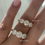 Size comparison of Portia 2ct and 3.14ct trilogy engagement rings in 18ct yellow gold