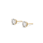 Side profile of yellow gold four-prong round diamond stud earrings