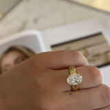 Seraphine 18ct yellow gold oval diamond engagement ring worn on finger