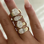 Four 18ct yellow gold solitaire rings with oval and cushion lab-grown diamonds on hand