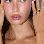 Woman styling Florence marquise wrap diamond ring with layered gold jewelry