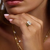 Close-up of wide 18ct yellow gold band with large emerald cut diamond centerstone