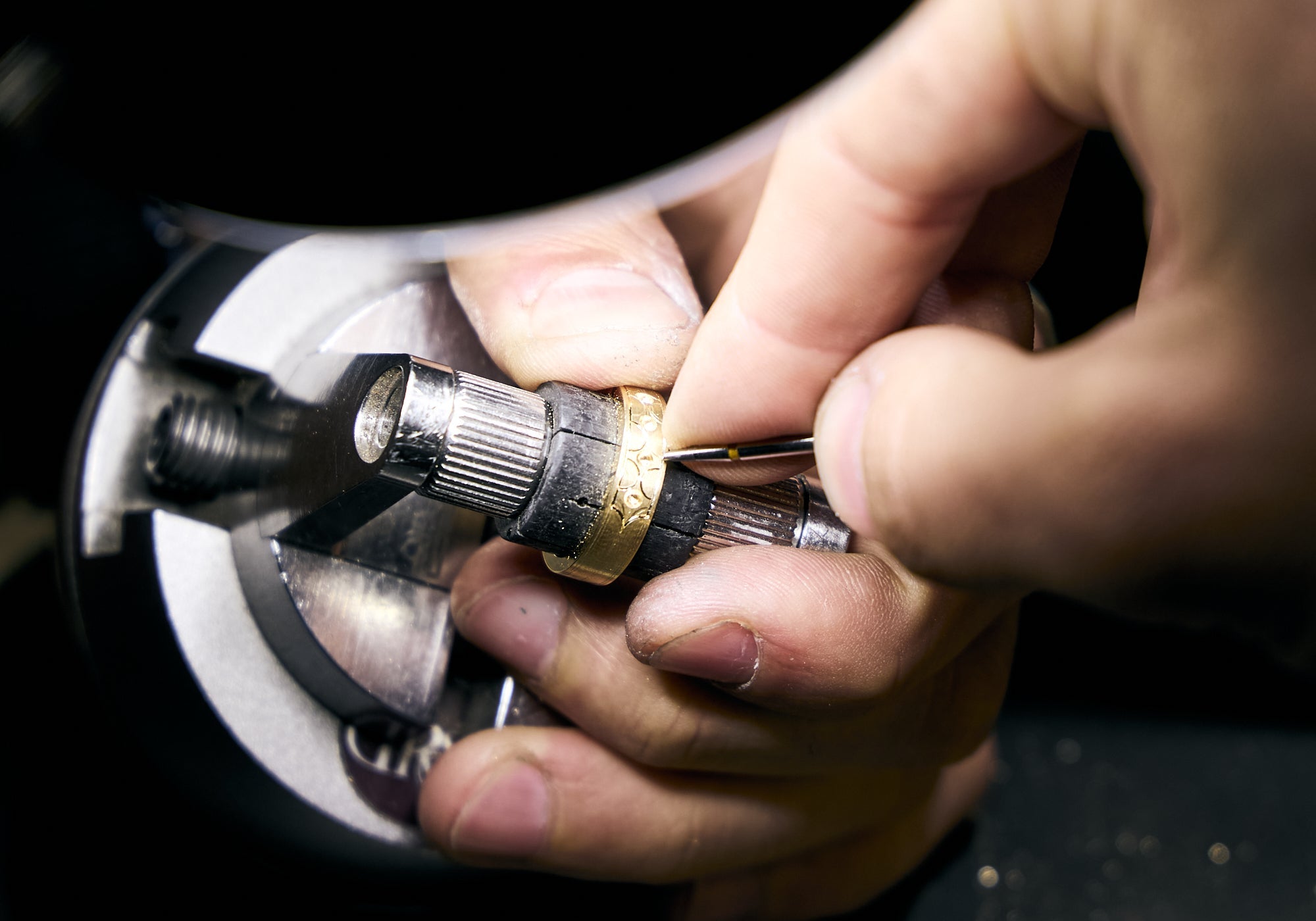 hand engraving a gold wedding band 