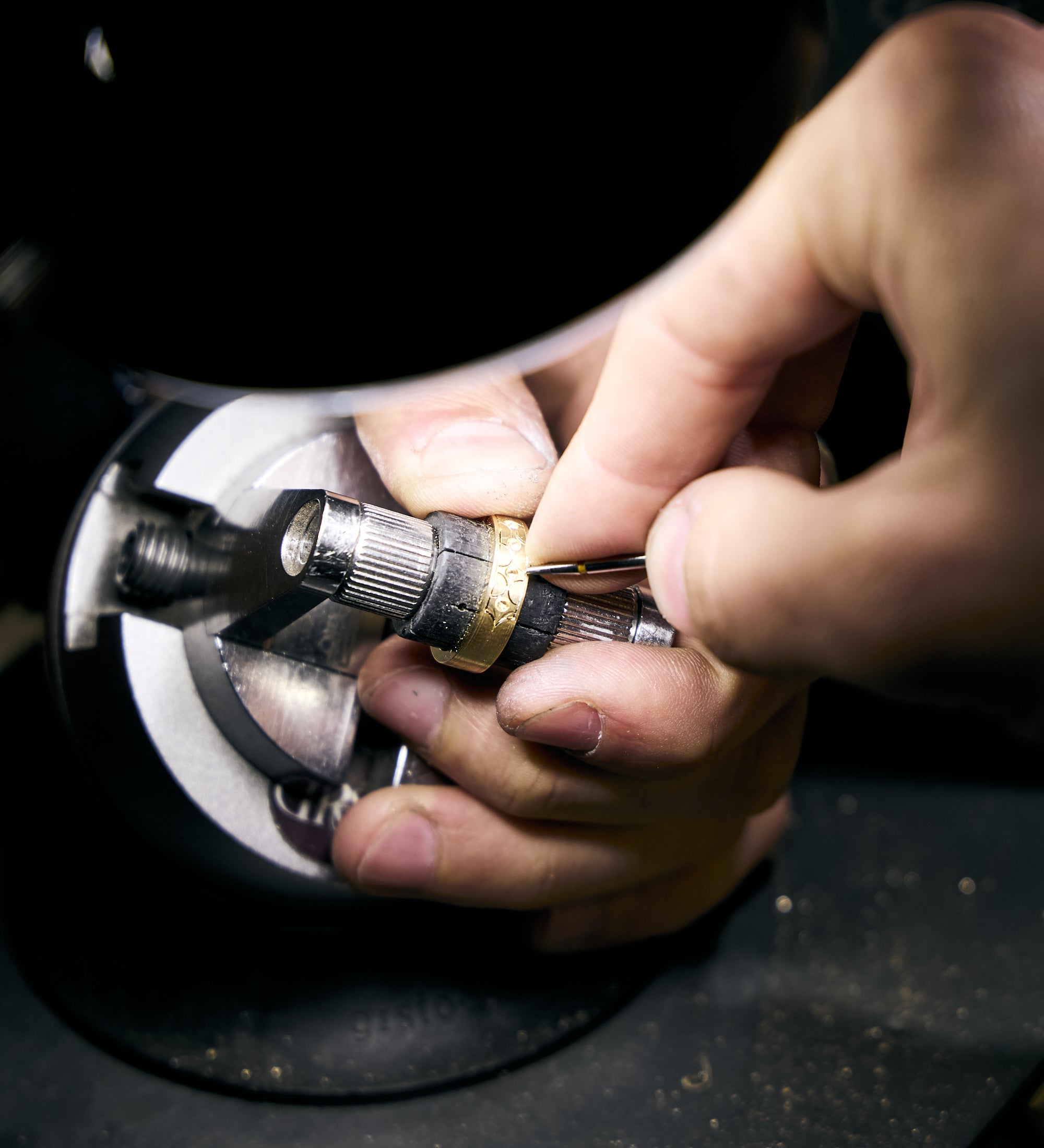 hand engraving a gold wedding band 