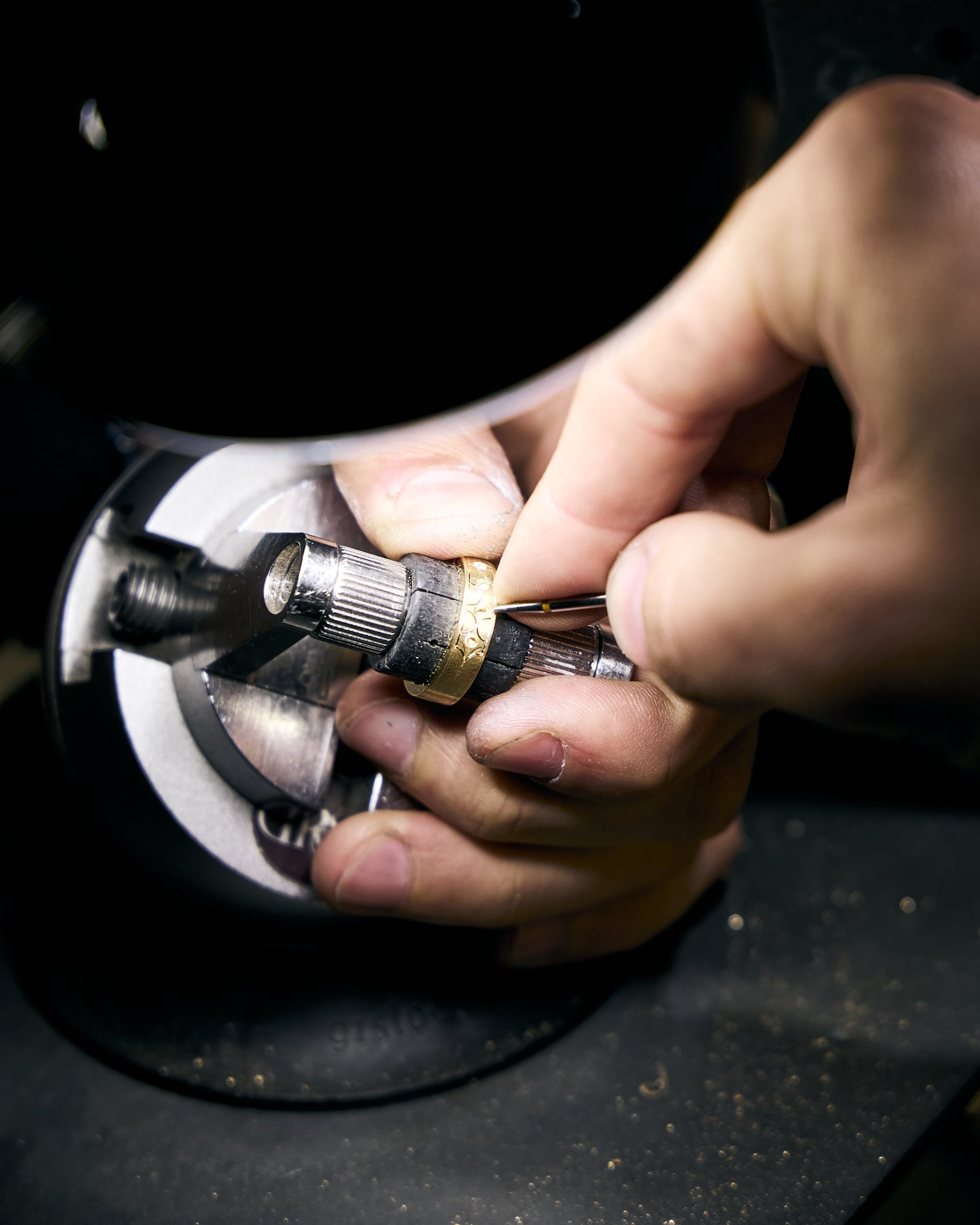 hand engraving a gold wedding band 