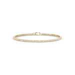 Horizontal studio shot of yellow gold mini tennis bracelet with central clasp