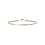 Horizontal studio shot of yellow gold mini tennis bracelet with central clasp