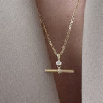 Our Birthstone T-Bar Pendant can feel bold, classic or effortlessly understated simply by changing the way you style her. Choose from a range of our signature chains or classic pearls to curate your perfect T-Bar look. 

Pictured:
1-3: Heirloom Chain 
4-6: Classic Pearls 
7-9: Base Chain